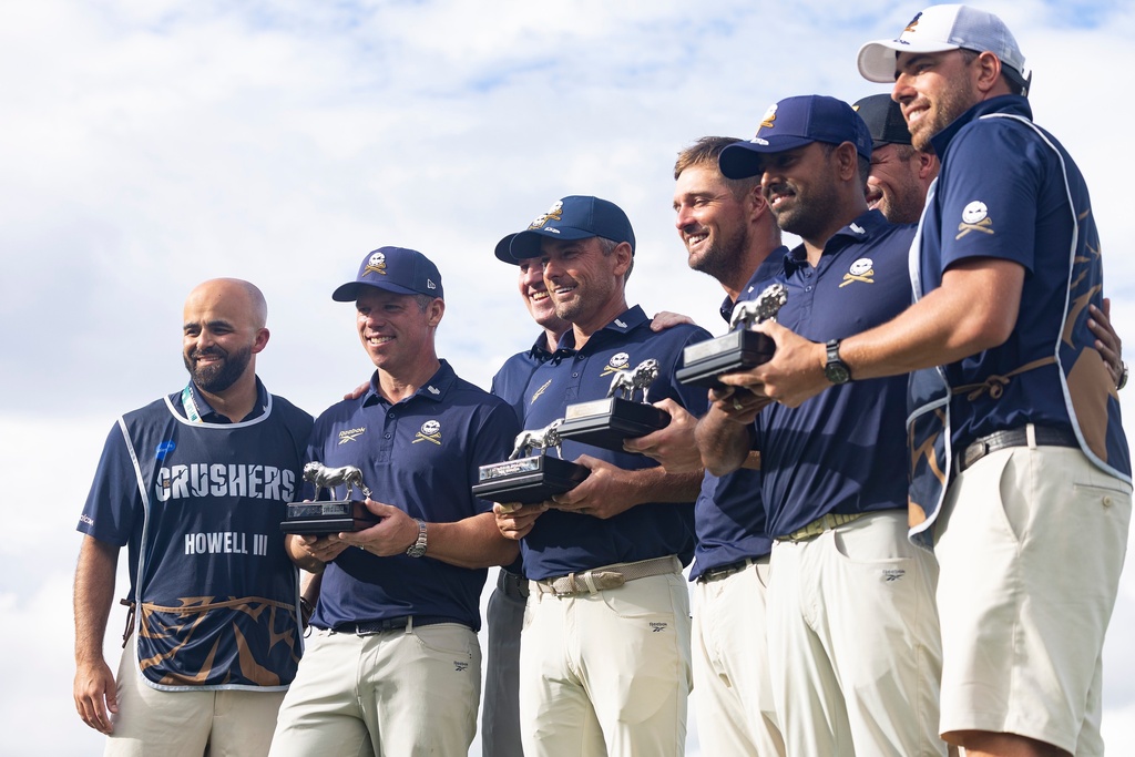 First-place team champions, Crushers GC, pose for a photo with their trophies after the final round of LIV Golf South Africa at The Club at Steyn City, Sunday, March 22, 2026, in Midrand, South Africa. (LIV Golf via AP)