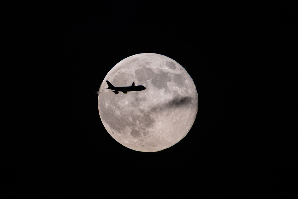 A UPS Boeing 747 inbound from Anchorage, Alaska, passes in front of the supermoon as it approaches Louisville Muhammad Ali International Airport on Wednesday, Nov. 5, 2025, in Louisville, Ky. (AP Photo/Jon Cherry)