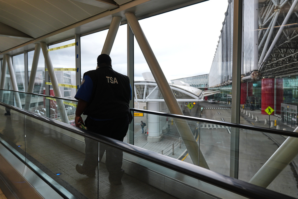 A Transportation Security Administration agent leaves the terminal following their shift at Baltimore/Washington International Thurgood Marshall Airport in Baltimore, Monday, March 23, 2026. (AP Photo/Stephanie Scarbrough)
