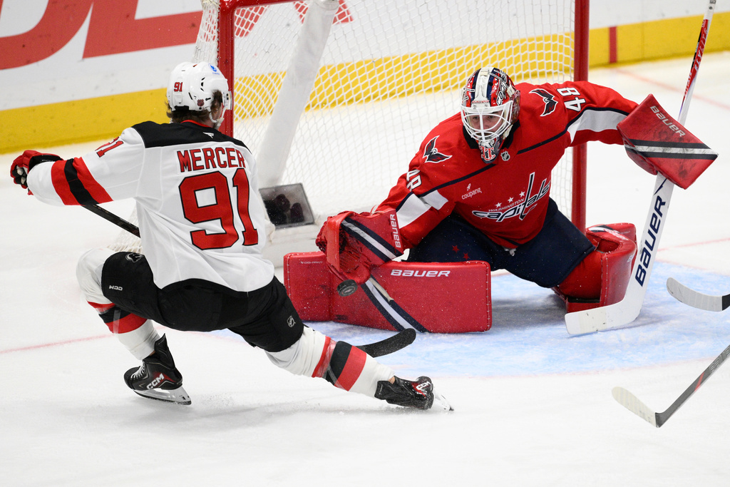 Washington Capitals goaltender Logan Thompson (48) stops the puck shot by New Jersey Devils center Dawson Mercer (91) during the third period of an NHL hockey game Friday, March 20, 2026, in Washington. (AP Photo/Nick Wass)