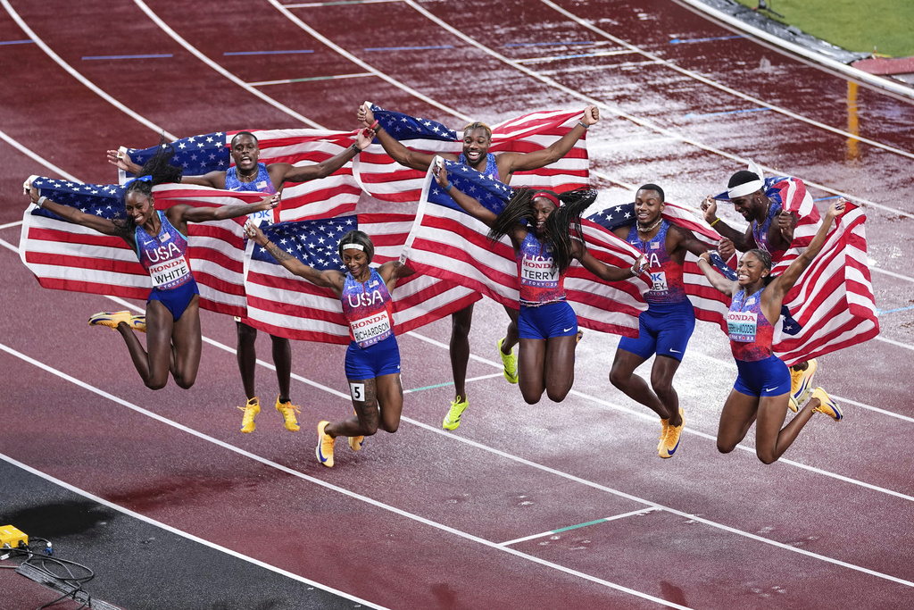 United States' Kayla White, Sha'Carri Richardson, Twanisha Terry and Melissa Jefferson-Wooden of the women's 4 X 100 meters relay final and Christian Coleman, Noah Lyles, Courtney Lindsey and Kenneth Bednarek of the men's 4 X 100 meters relay final celebrate both of their gold medals at the World Athletics Championships in Tokyo, Sunday, Sept. 21, 2025. (AP Photo/Abbie Parr)