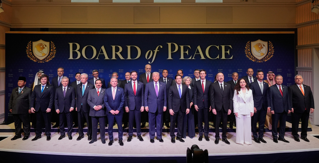 FILE - President Donald Trump stands with other World leaders before a Board of Peace meeting at the U.S. Institute of Peace, Feb. 19, 2026, in Washington. (AP Photo/Mark Schiefelbein, File)