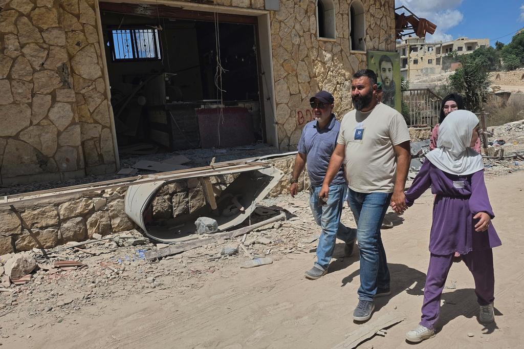 People walk through the village of Zawtar al-Gharbiyeh after the Lebanese army deployed to the village in southern Lebanon, Sunday, July 26, 2026. (AP Photo/Ahmad Mantash)