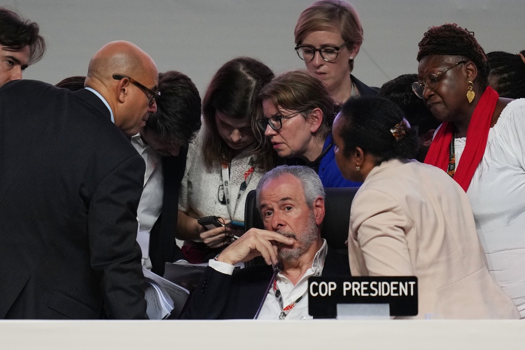 André Corrêa do Lago, COP30 president, sits as Simon Stiell, United Nations climate chief, left, speaks with other U.N. officials during a plenary session at the COP30 U.N. Climate Summit, Saturday, Nov. 22, 2025, in Belem, Brazil. (AP Photo/Andre Penner)