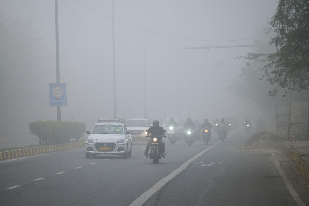 Traffic moves through dense smog in the morning in New Delhi, India, Monday, Dec. 15, 2025. (AP Photo)