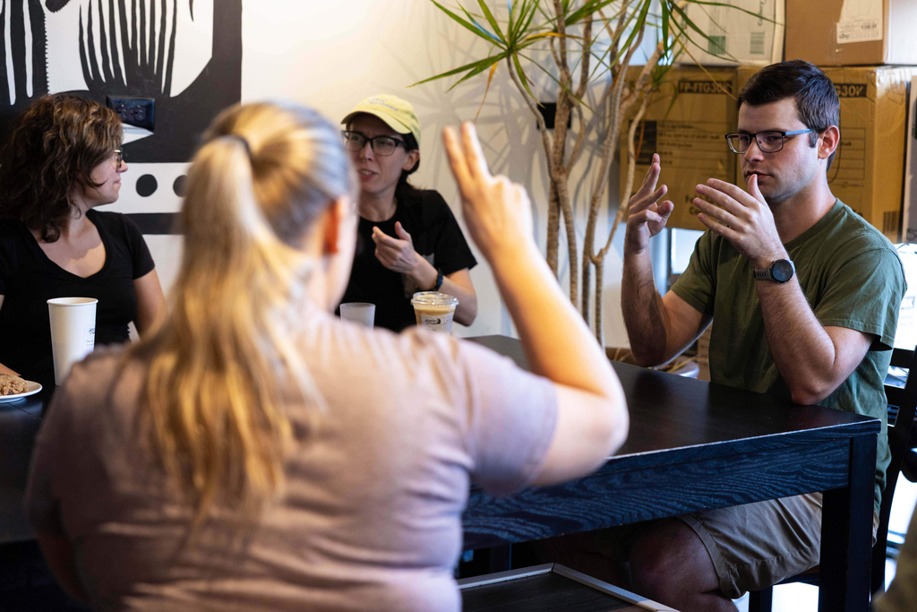 People attending a weekly meet up called "Sign Squad" communicate in American Sign Language at the Woodstock Cafe on June 10, 2025, in Portland, Ore. (Allison Barr/The Oregonian via AP)
