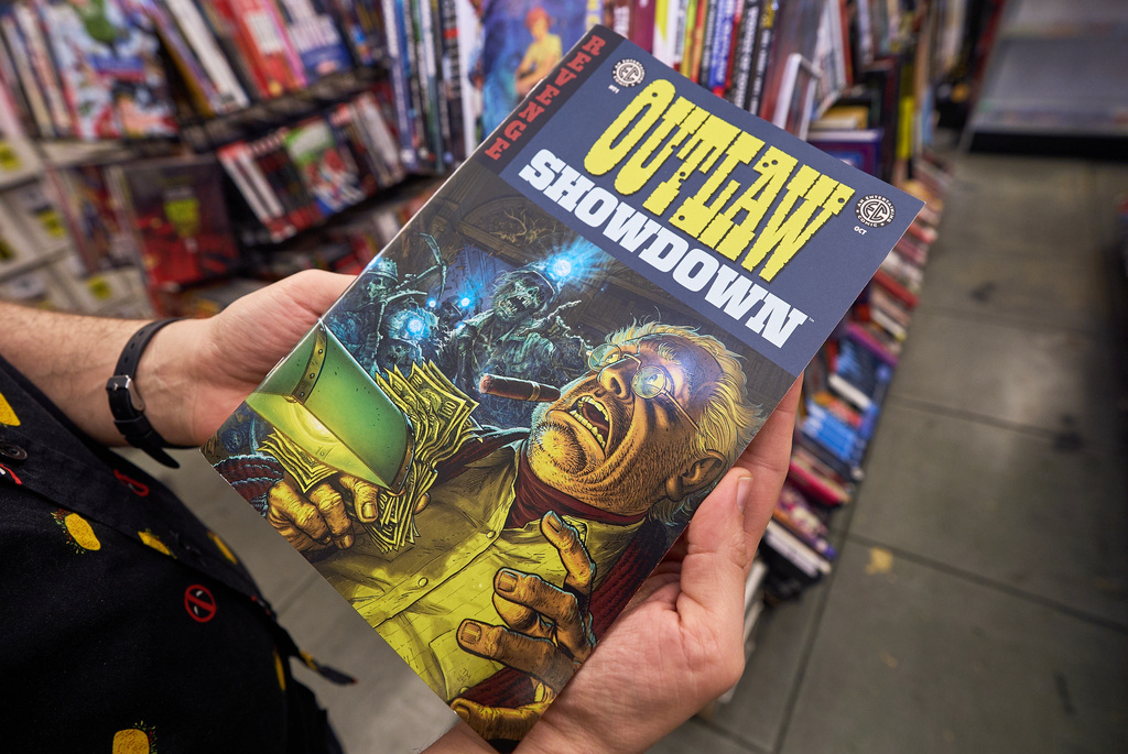A EC Comics "Outlaw Showdown" comic book is displayed at Golden Apple Comics store, in Los Angeles, Tuesday, Nov. 18, 2025. (AP Photo/Damian Dovarganes)