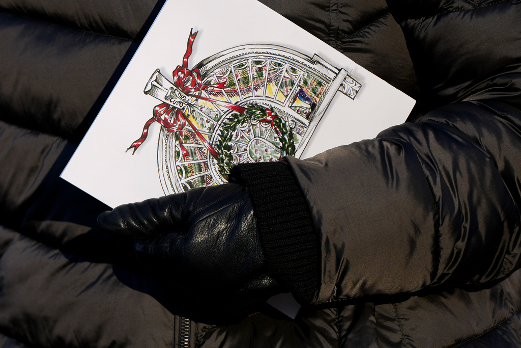 A woman holds a brochure following a White House tour, Wednesday, Dec. 3, 2025, in Washington, as tours resume for the first time since construction of a new ballroom began at the White House. (AP Photo/Julia Demaree Nikhinson)