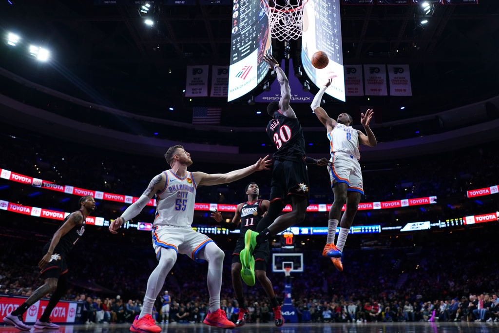 Oklahoma City Thunder's Jalen Williams (8) goes up for a shot against Philadelphia 76ers' Adem Bona (30) during the first half of an NBA basketball game Monday, March 23, 2026, in Philadelphia. (AP Photo/Matt Slocum)