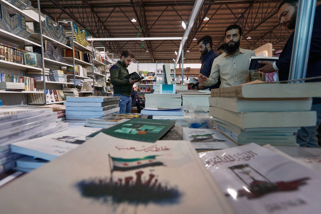 Visitors browse books during the 57th Damascus International Book Fair in Damascus, Syria, Monday, Feb. 16, 2026, the first edition since the collapse of the Assad regime. (AP Photo/Omar Sanadiki)
