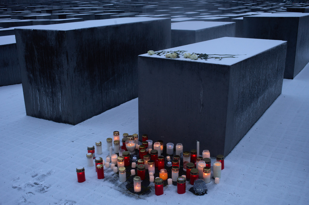 Candles placed in front of a concrete slab of the Holocaust memorial to mark the International Holocaust Memorial Day in Berlin, Germany, Tuesday, Jan. 27, 2026. (AP Photo/Markus Schreiber)