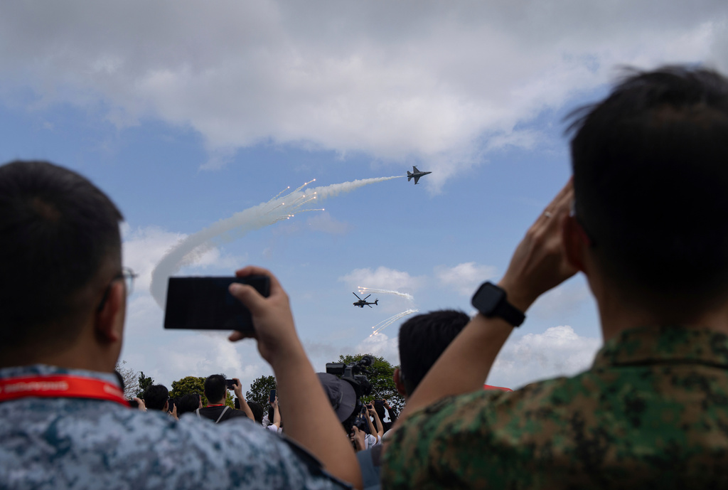 Uniformed members of the Singapore Armed Forces take photos and videos of an air display during the Singapore Air Show on Thursdsay, Feb. 5, 2026. (AP Photo/Anton L. Delgado)
