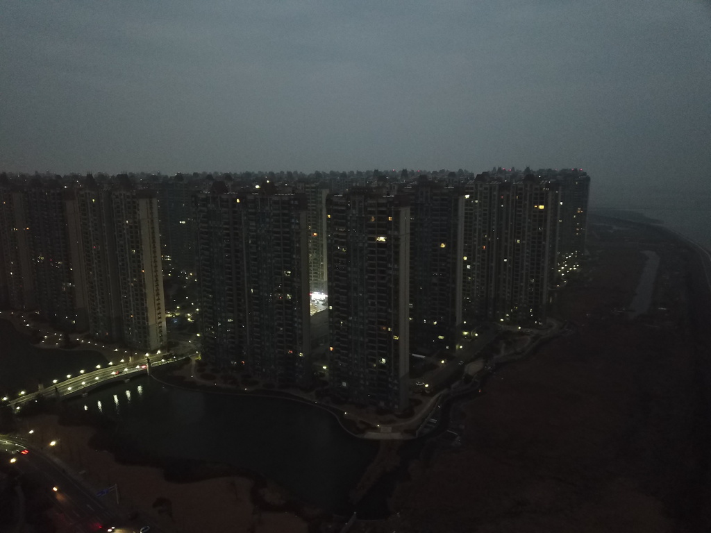 Many apartments remain empty and unlit as dusk falls at the semi-abandoned "Life in Venice" housing complex in Qidong, on China's east coast, Feb. 5, 2026. (AP Photo/Dake Kang)
