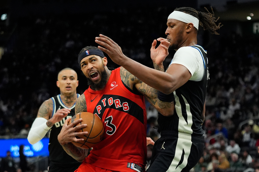 Toronto Raptors' Brandon Ingram, front left, drives to the basket against Milwaukee Bucks' Myles Turner, right, during the first half of an NBA basketball game Sunday, Feb. 22, 2026, in Milwaukee. (AP Photo/Aaron Gash)