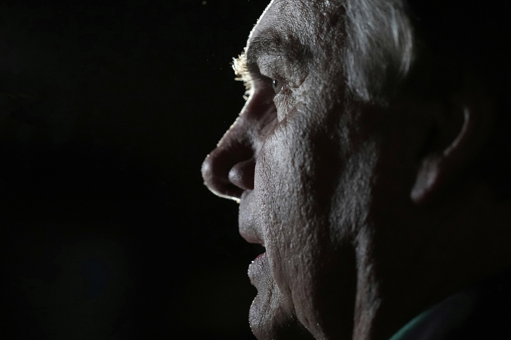 FILE - Former President Jair Bolsonaro talks with reporters after arriving at the airport in Brasilia, Brazil, June 30, 2023, days after he was barred from running for office again until 2030 after a panel of judges concluded that he abused his power and cast unfounded doubts on the country's electronic voting system. (AP Photo/Eraldo Peres, File)