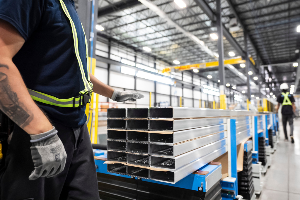 FILE - Workers prepare extruded aluminum product for packaging at Magna Aluminum Profile's fully electric powered extrusion facility in Salaberry-de-Valleyfield, Quebec, Canada, on Sept. 3, 2025. (Christopher Katsarov/The Canadian Press via AP, File)