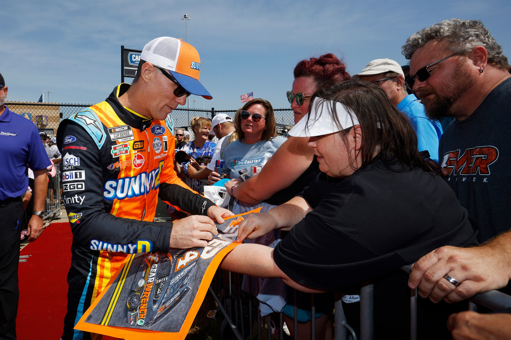 FILE - Kevin Harvick signs autographs before a NASCAR Cup Series auto race at Kansas Speedway in Kansas City, Kan., Sept. 10, 2023. (AP Photo/Colin E. Braley, File)