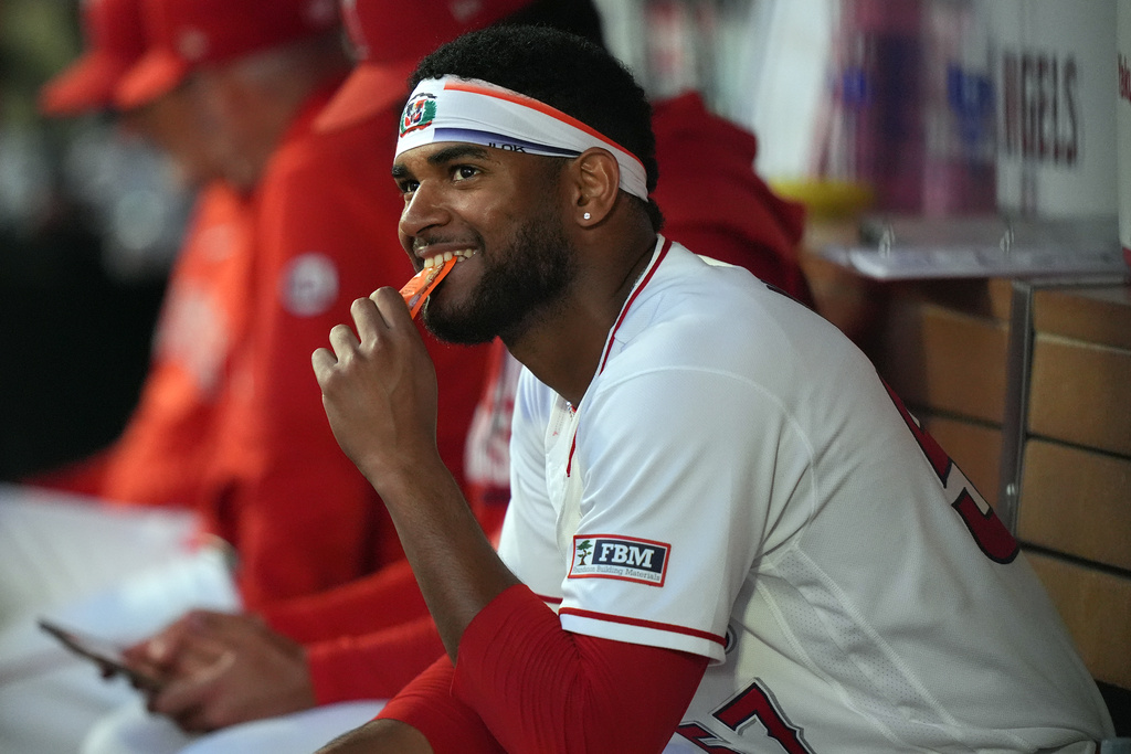 Los Angeles Angels pitcher Walbert Urena (57) smiles in the dugout after retiring the Houston Astros during the fourth inning in a baseball game Tuesday, June 9, 2026, in Anaheim, Calif. (AP Photo/Scott Strazzante)