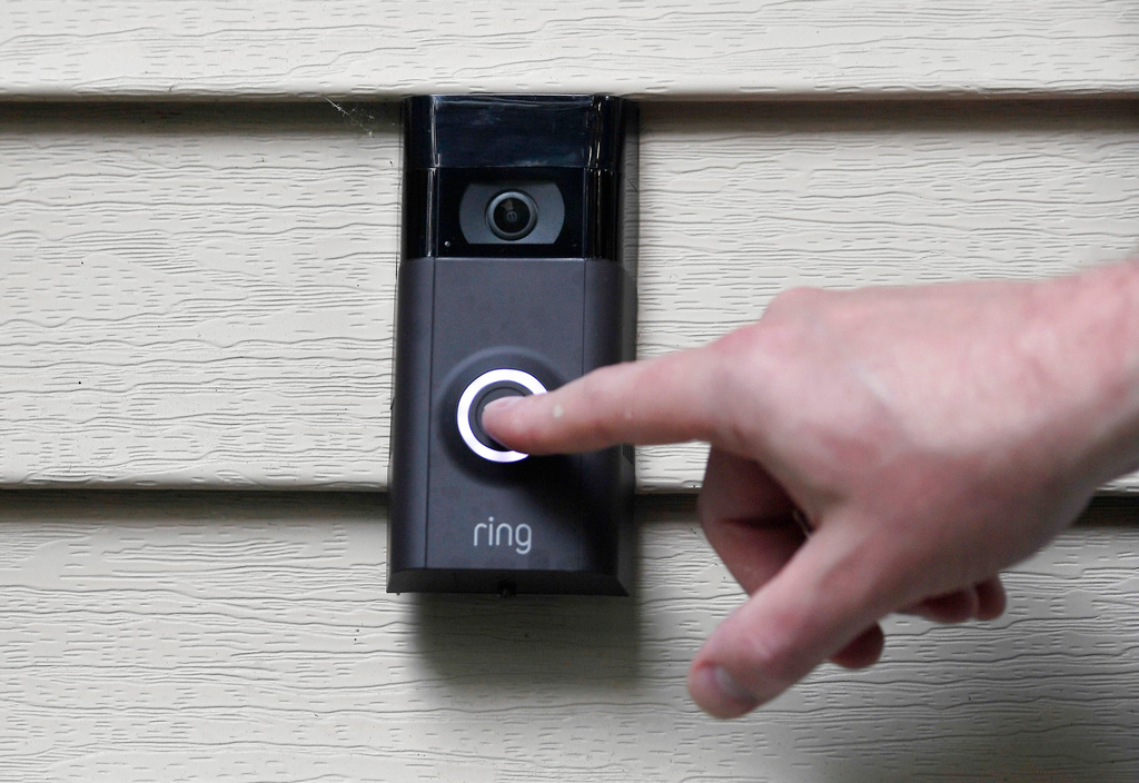 FILE - A person pushes the doorbell on their Ring doorbell camera, July 16, 2019, in Wolcott, Conn. (AP Photo/Jessica Hill, File)