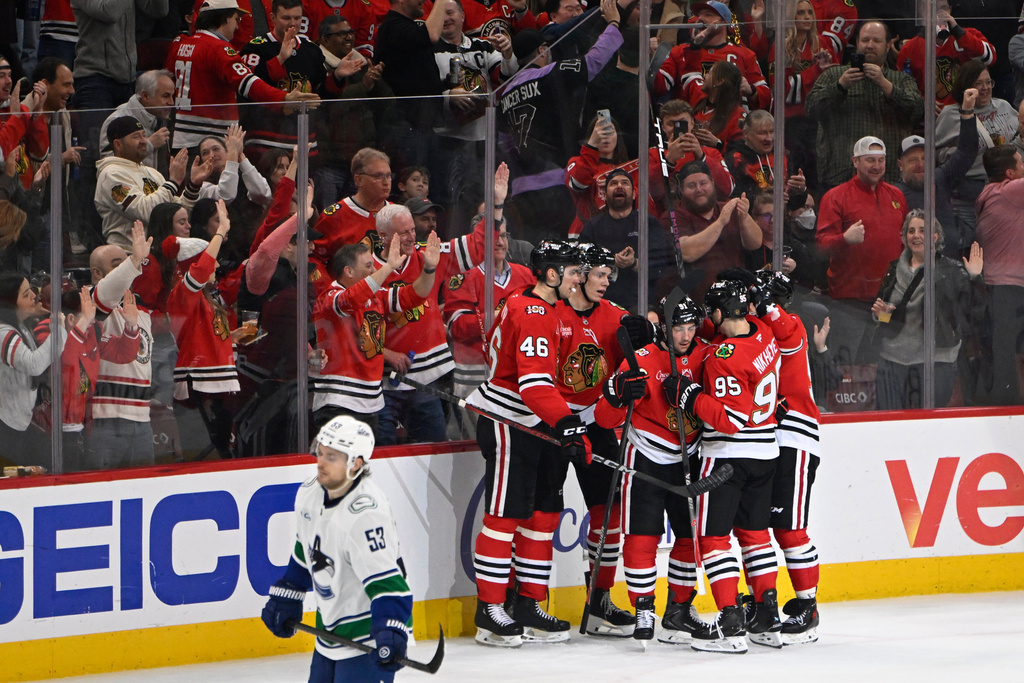 Chicago Blackhawks' Frank Nazar (91) celebrates with teammates after scoring a goal during the second period of an NHL hockey game against the Vancouver Canucks in Chicago, Friday, March 6, 2026. (AP Photo/Paul Beaty)