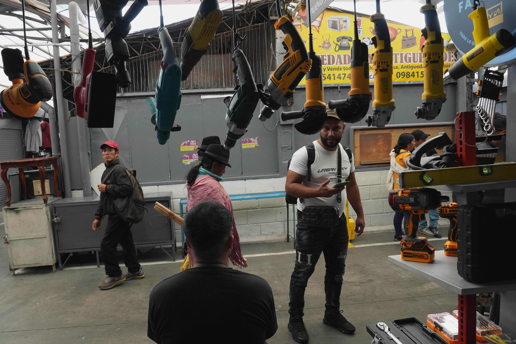A man stops in front of a store that mostly sells tools imported from China at the Arenas Market in Quito, Ecuador, Saturday, Jan. 31, 2026. (AP Photo/Dolores Ochoa).