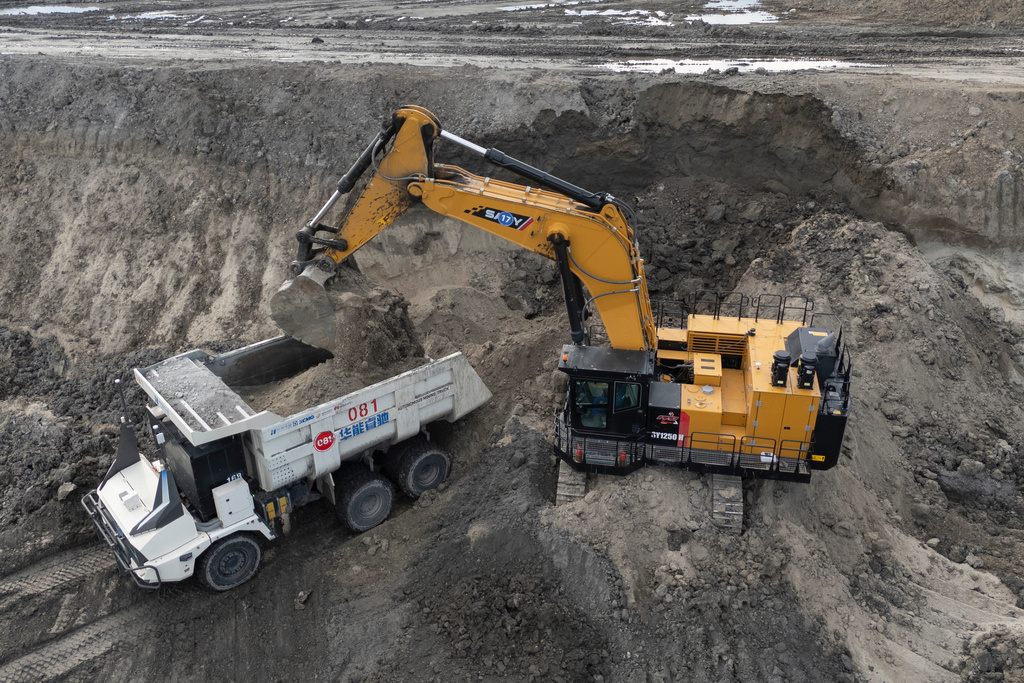 An excavator loads an autonomous mining truck in the Huaneng Yimin open-pit coal mine in Hulunbuir in northern China's Inner Mongolia province China, Monday, Sept. 15, 2025. (AP Photo/Ng Han Guan)