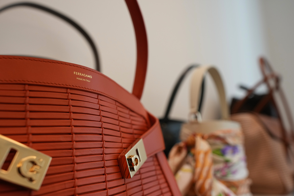 Bags are displayed as James Ferragamo, chief product officer for the Salvatore Ferragamo group, talks during an interview with the Associated Press in Milan, Italy, Wednesday, April 22, 2026. (AP Photo/Antonio Calanni) CORRECTION: Corrects role to chief product officer instead of Men's and Women's Leather Product Director.