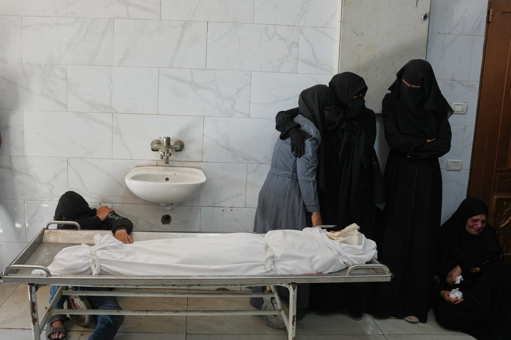 Palestinian women mourn over the body of 10-year-old Amir Shaaban, who was killed in an Israeli military strike, before his funeral at Nasser Hospital in Khan Younis, southern Gaza Strip, Wednesday, July 8, 2026. (AP Photo/Abdel Kareem Hana)