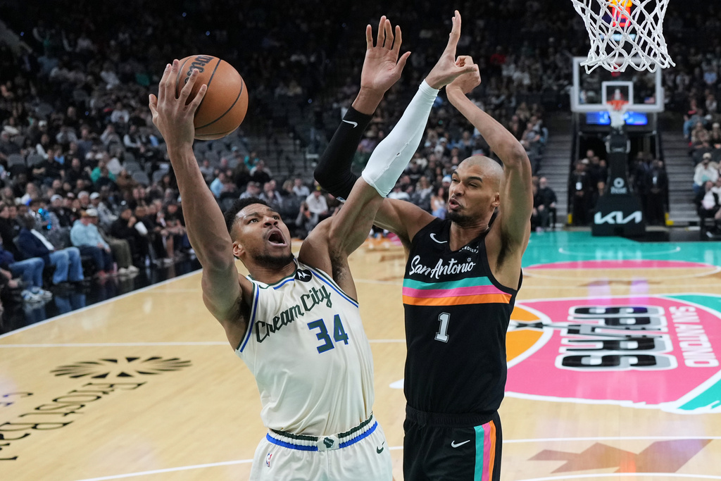 Milwaukee Bucks forward Giannis Antetokounmpo (34) drives to the basket against San Antonio Spurs forward Victor Wembanyama (1) during the first half of an NBA basketball game in San Antonio, Thursday, Jan. 15, 2026. (AP Photo/Eric Gay)