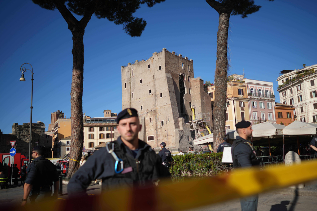 Police officers patrol the medieval tower Torre dei Conti area near the Roman Forum after it had partially collapsed during renovation works, meters away from the Colosseum in Rome, Monday, Nov. 3, 2025. (AP Photo/Andrew Medichini)
