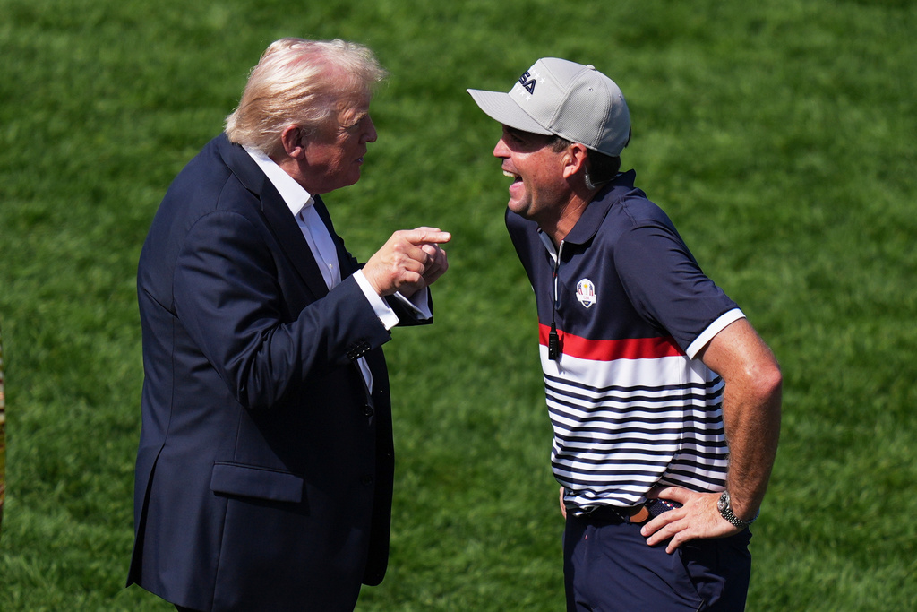 President Donald Trump greets United States team captain Keegan Bradley on the first hole at Bethpage Black golf course during the Ryder Cup golf tournament, Friday, Sept. 26, 2025, in Farmingdale, N.Y. (AP Photo/Seth Wenig)