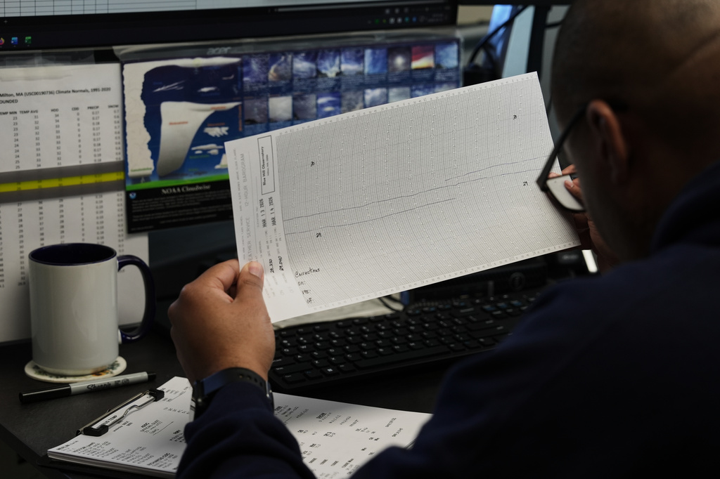 Matthew Douglas reads a record of atmospheric pressure in his office at the Blue Hill Observatory and Science Center, Saturday, March 14, 2026, in Milton, Mass. (Laura Martin Agudelo/MIT Graduate Program in Science Writing via AP)