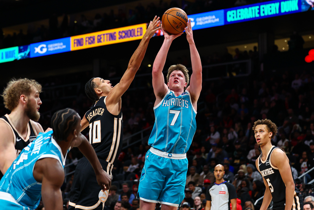 Charlotte Hornets guard Kon Knueppel (7) looks to shoot against Atlanta Hawks forward Zaccharie Risacher (10) during the first half of an NBA basketball game, Saturday, Feb. 7, 2026, in Atlanta. (AP Photo/Colin Hubbard)