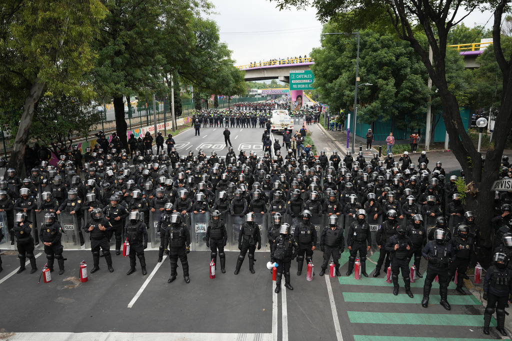 Police block an avenue to prevent protesting teachers from marching to the stadium that will host the opening match of the FIFA World Cup in Mexico City, Tuesday, June 9, 2026. (AP Photo/Eduardo Verdugo)