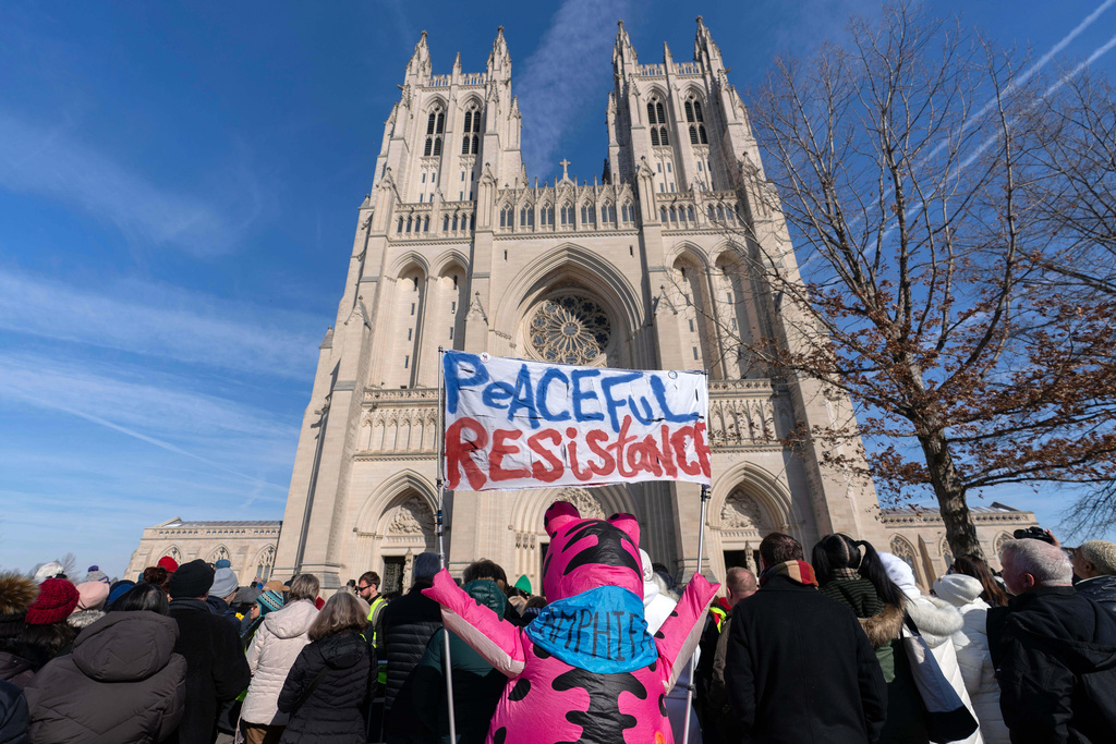 People gather to watch the Buddhist monks as they walk outside of the Washington National Cathedral after an event during the Walk For Peace, Tuesday, Feb. 10, 2026, in Washington. (AP Photo/Jose Luis Magana)