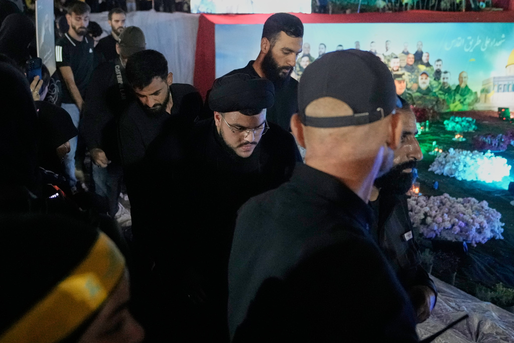 Mohammad Mahdi Nasrallah, center, son of former Hezbollah leader Hassan Nasrallah, arrives for a gathering at the site where his father was killed in Israeli airstrikes on Sept. 27, 2024, a day before the first anniversary of his death, in the Haret Hreik suburb south of Beirut, Lebanon, Friday, April 26, 2025. (AP Photo/Hassan Ammar)
