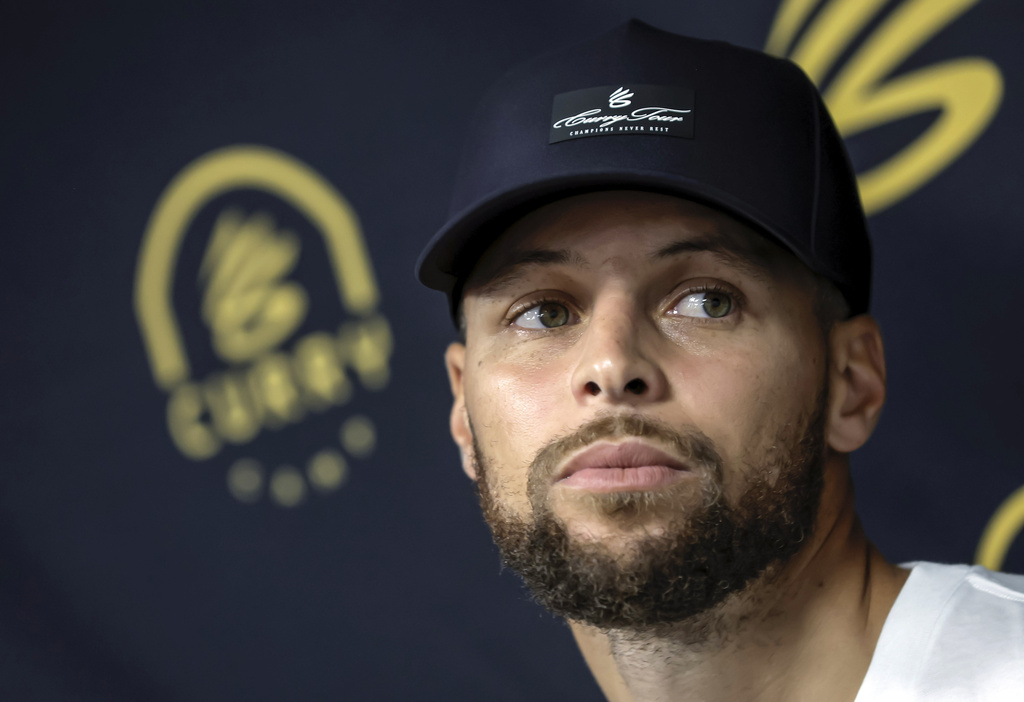 Golden State Warriors' Stephen Curry answers questions from reporters during a break from his Under Armour Camp at Arrillaga Family Gym in Menlo Park, Calif., on Thursday, Aug. 14, 2025. (Carlos Avila Gonzalez/San Francisco Chronicle via AP)