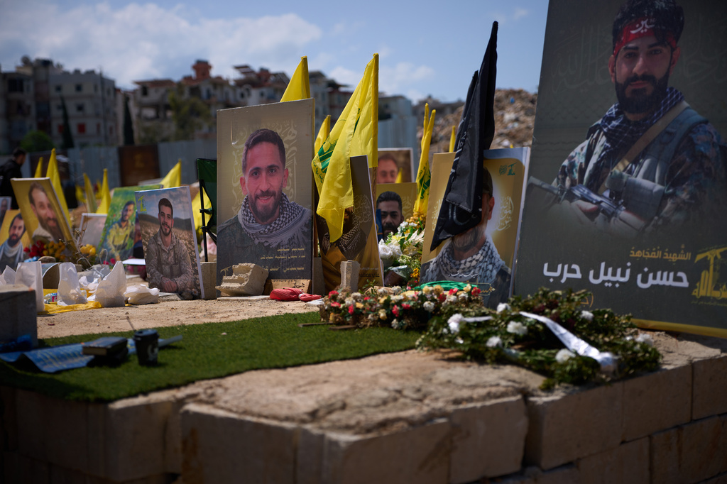 Graves bearing photos of Hezbollah fighters killed in Israeli strikes are seen in a cemetery in Choueifat, Lebanon, Monday, April 13, 2026. (AP Photo/Emilio Morenatti)
