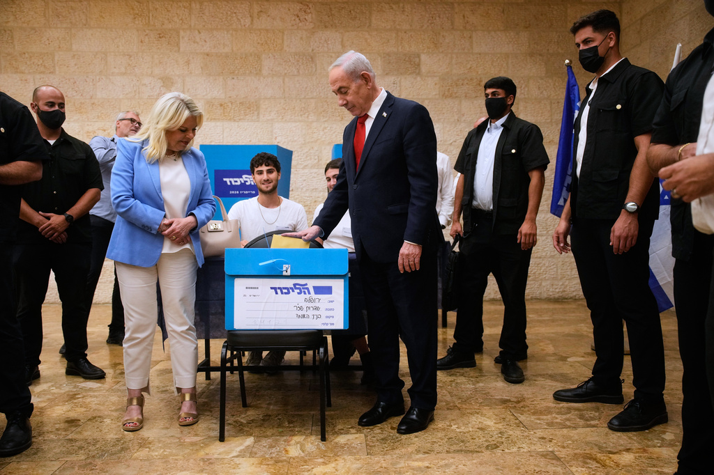 Israeli Prime Minister Benjamin Netanyahu, right, and his wife, Sara, cast their ballots in the Likud party primary elections ahead of Israel's general election in October, in Jerusalem, Monday, Aug. 17, 2026. (AP Photo/Ohad Zwigenberg, Pool)