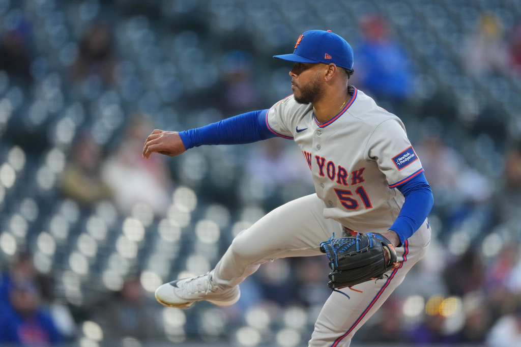 New York Mets starting pitcher Freddy Peralta works against the Colorado Rockies in the first inning of a baseball game, Wednesday, May 6, 2026, in Denver. (AP Photo/David Zalubowski)