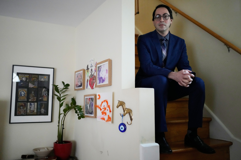 Ali Tarokh sits on a stair at his home in Chicago, Wednesday, March 25, 2026. (AP Photo/Nam Y. Huh)