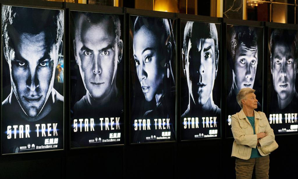 FILE - A visitor walks past a line of posters for the forthcoming film "Star Trek," on the first day of ShoWest, the largest annual convention for the motion picture industry, in Las Vegas on March 30, 2009. (AP Photo/Chris Pizzello, File)