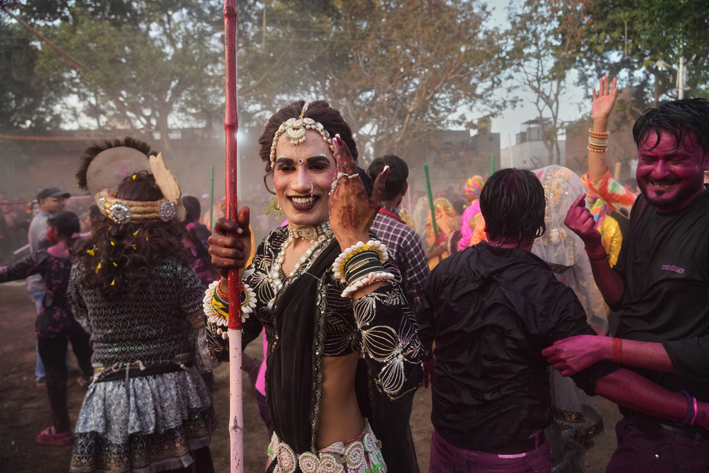 A transgender person participates along with others during Holi festival celebrations at the Shri Krishna Janmabhoomi Temple complex in Mathura, India, on Feb. 27, 2026. (AP Photo/Manish Swarup)