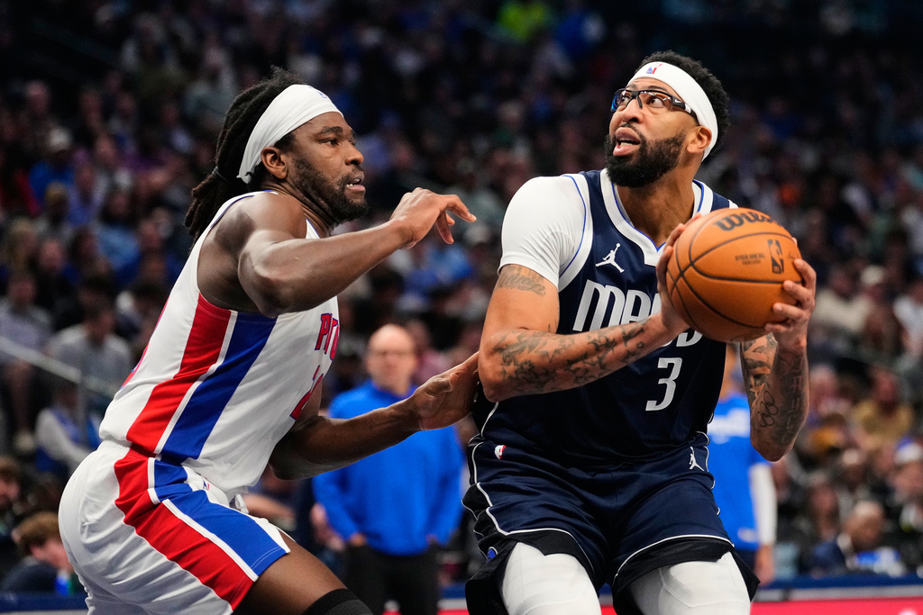 Dallas Mavericks forward Anthony Davis (3) works for a shot attempt against Detroit Pistons forward Isaiah Stewart, left, in the first half of an NBA basketball game in Dallas, Thursday, Dec. 18, 2025. (AP Photo/Tony Gutierrez)