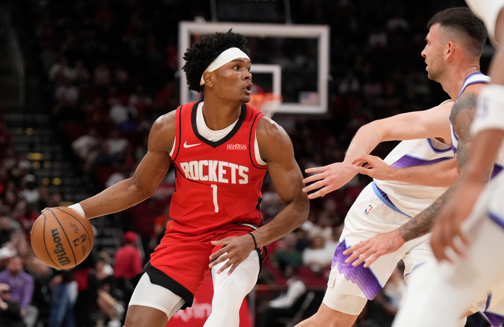 Houston Rockets guard Amen Thompson (1) controls the ball against the Utah Jazz during the first half of an NBA basketball game, Friday, April 3, 2026, in Houston. (AP Photo/Karen Warren)