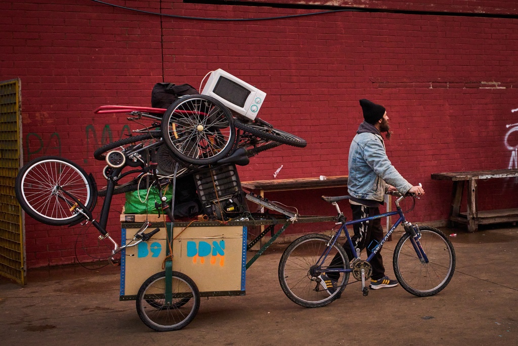 FILE - A migrant carries his belongings at an abandoned school building where hundreds of mostly undocumented migrants had been living, in Badalona, near Barcelona, Spain, Wednesday, Dec. 17, 2025. (AP Photo/Emilio Morenatti, File)