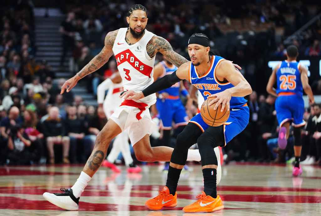 New York Knicks' Josh Hart (right) protects the ball from Toronto Raptors' Brandon Ingram (3) during first half NBA basketball action in Toronto on Wednesday, Jan. 28, 2026. (Frank Gunn/The Canadian Press via AP)