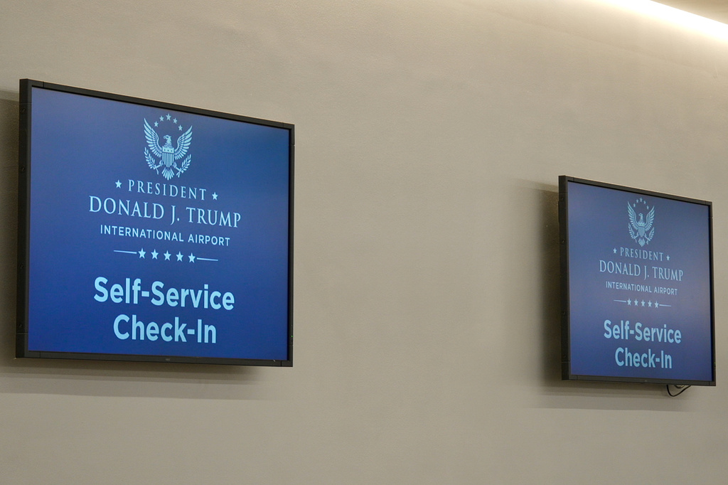 A monitor at a check-in counter displays the name of the rebranded Donald J. Trump International Airport in West Palm Beach, Fla., Thursday, July 9, 2026. (AP Photo/Cody Jackson)