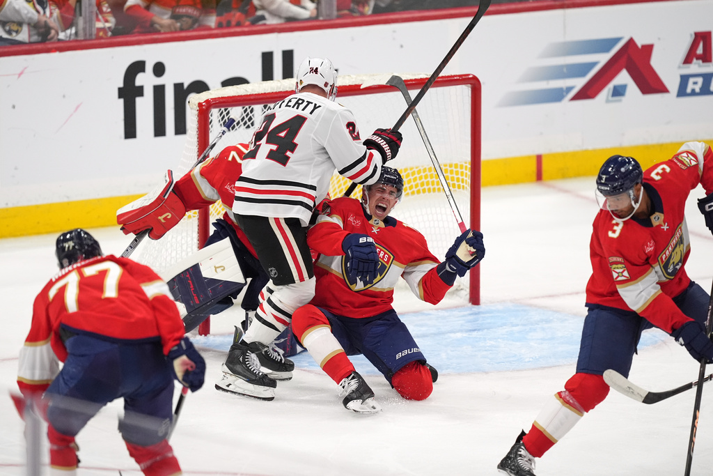 Florida Panthers center Evan Rodrigues (17) reacts to an apparent injury as he clashes with Chicago Blackhawks center Sam Lafferty (24) in front of Florida Panthers goaltender Sergei Bobrovsky (72) during the second period of an NHL hockey game, Tuesday, Oct. 7, 2025, in Sunrise, Fla. (AP Photo/Rebecca Blackwell)