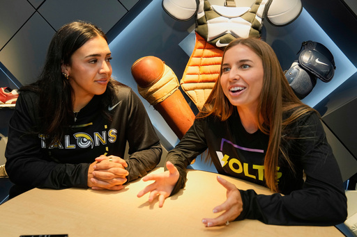 FILE - Athletes Unlimited Softball League players Sharlize Palacios, left, of the Talons, and Sis Bates of the Bolts, are interviewed at Major League Baseball's headquarters in New York, Thursday, May 29, 2025. (AP Photo/Richard Drew, File FILE - Athletes Unlimited Softball League players Sharlize Palacios, left, of the Talons, and Sis Bates of the Bolts, are interviewed at Major League Baseball's headquarters in New York, Thursday, May 29, 2025. (AP Photo/Richard Drew, File